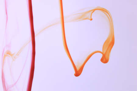 Red & Orange Ink Lines in Waterの写真素材