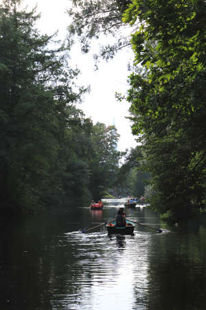 Far away river with trees on both coasts and rowing boats. Saint-Petersburg.