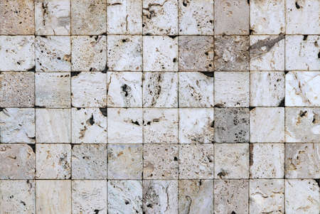 White squares masonry tiles texture. Stone bricks cladding backdrop. Exterior decoration wall facade background.の写真素材