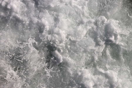 Sea wave foam texture. White marine aqua motion surface background. Outdoor water froth swirls backdrop.の写真素材