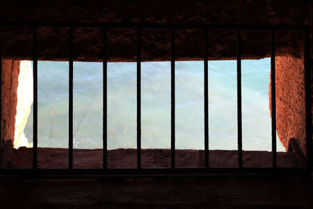 Ancient tower window with bars. Sea view. Bedesten Alanya fortress. Turkey.