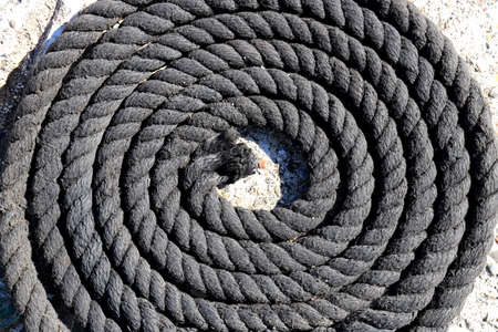 Twisted black sea rope. Nautical marine background.の写真素材