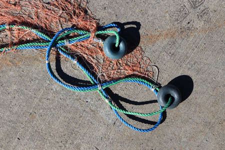 Fishnet with two buoys on rope. Nautical marine background.