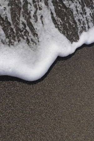 Sea beach texture with wave foam. Marine background.の写真素材