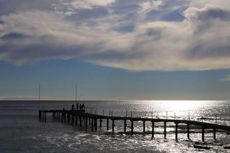 Fishermen on pier construction catching fish. Alanya. Turkey.の写真素材