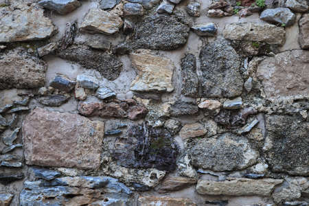 Stones wall texture. Rocky cliff stones surface background.