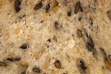 Diet food background. Fief grains bread crumb surface. Flax seeds bread crumb texture.