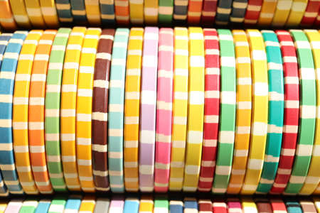 Many colored chips backdrop. Lot multicolor assorted gambling playing chips surface. Colorful casino...