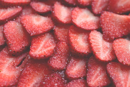 Sliced strawberry in sugar filling background. Red healthy tasty strawberry's with sugar texture....