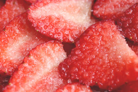 Red healthy tasty strawberry's with sugar texture. Fresh vitamin berry backdrop. Sliced strawberry in sugar filling background.の写真素材