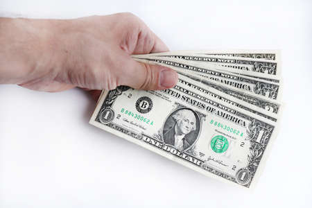 In hand dollars money stack. Arm holding United States of America dollars banknotes.