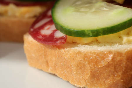 Sandwiches with eggs and cheese butter with sausage cucumber slicesの写真素材