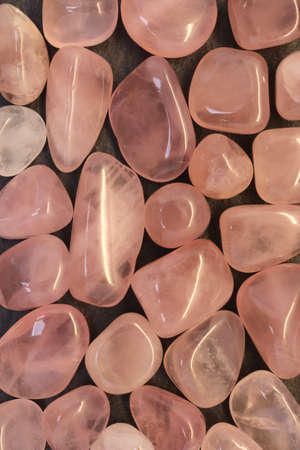 Rose quartz jewel texture on light surface background. Scarce mineral pebbles creative.
