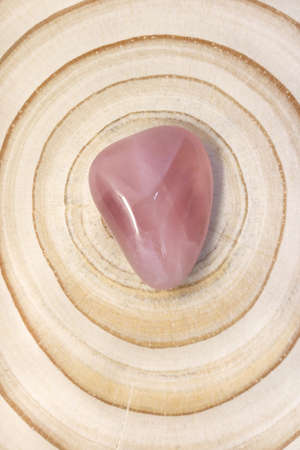 Rose quartz jewel texture on light surface background. Scarce mineral pebbles creative.