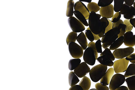 Gold obsidian rare jewel on half light surface texture. Pile mineral pebbles background. Place for...