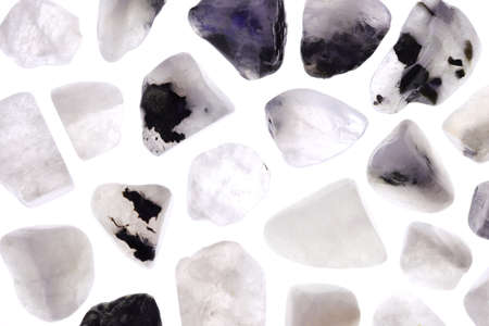 Moon stone heap jewel on brown varnished wood texture. Pile mineral pebbles background.の写真素材