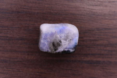 Moon stone heap jewel on half white light texture. Pile mineral pebbles background. Place for text.の写真素材