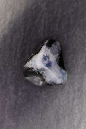 Moon stone heap jewel on half white light texture. Pile mineral pebbles background. Place for text.