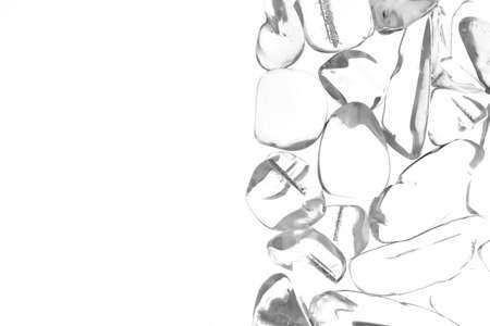 Clear quartz jewel heap on wood fiber circles background. Pile mineral pebbles texture.の写真素材