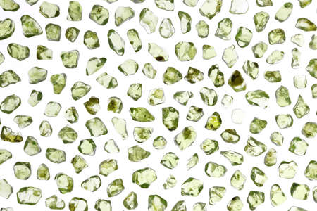 Olivine jewel texture in tweezers on light surface background. Macro closeup.の写真素材