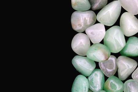 Green Aventurine jewel stone texture on black background. Macro closeup.の写真素材