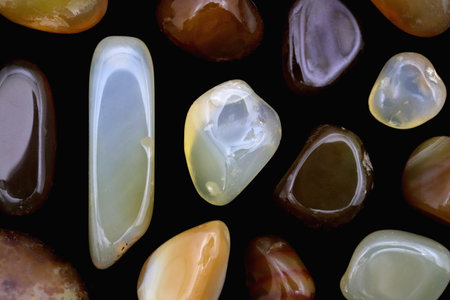 Yellow Agate jewel stone texture on light varnished wood background. Macro closeup.の写真素材
