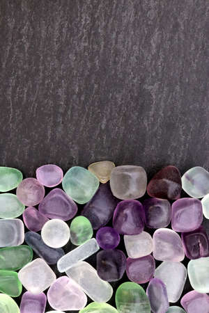 Fluorite rare jewel stones texture on light varnished wood background