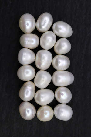 Pearl heap up jewel stones texture on light varnished wood background