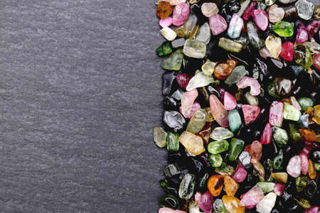 Tourmaline rare jewel stones texture on grey background