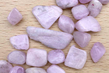 Morganite jewel stone texture on wood background. Macro closeup. Horizontal orientation.