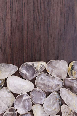 Rutilated quartz heap jewel stones texture backgroundの写真素材