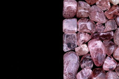 Strawberry quartz heap up jewel stones texture on light varnished wood backgroundの写真素材