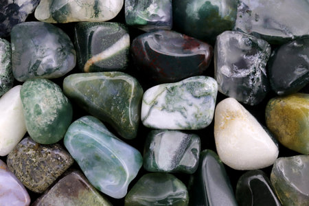 Moss agate heap jewel stones texture on half black background. Place for text.の写真素材