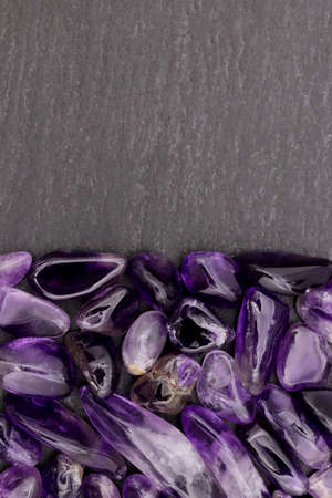 Amethyst rare jewel stones texture on light varnished wood background