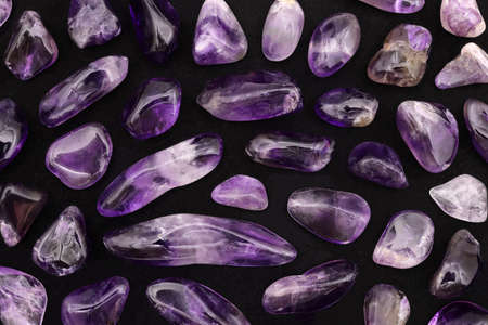 Amethyst rare jewel stones texture on light varnished wood backgroundの写真素材