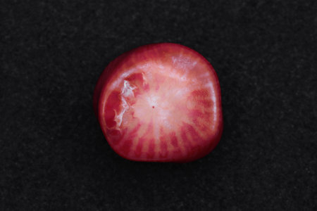 Red coral jewel stone texture on white light isolated background. Macro closeup.