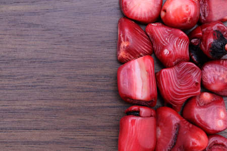 Red coral jewel stone texture on black background. Macro closeup.の写真素材