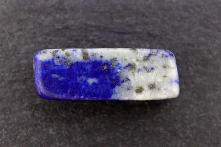 Lapis lazuli heap up jewel stones texture on brown varnished wood backgroundの写真素材