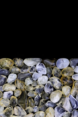 Citrine heap jewel stones texture on black backgroundの写真素材