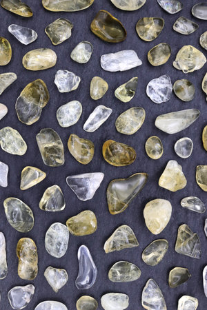 Citrine heap jewel stones texture on black background