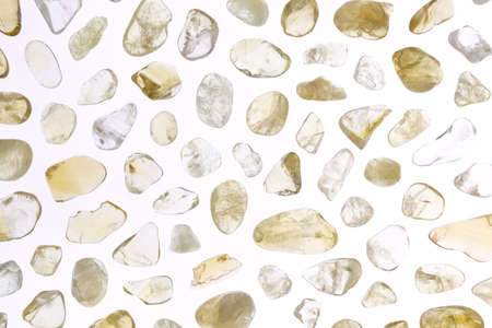 Citrine jewel stone texture in tweezers on white light isolated background. Macro closeup.の写真素材
