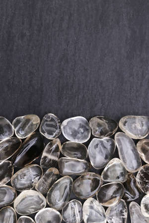 Smoky quartz jewel stone texture on black stone background. Macro closeup.