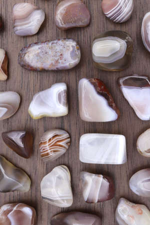 Persian agate heap jewel stones texture on half black background. Place for text.の写真素材