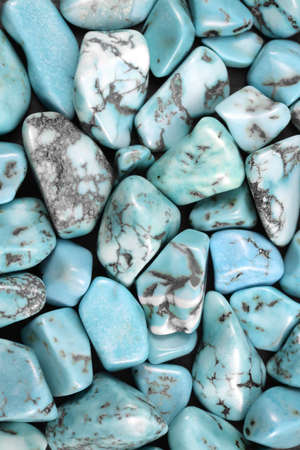 Turquoise heap jewel stones texture on half black background. Place for text.の写真素材