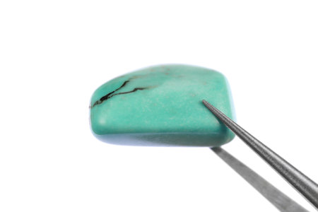 Turquoise jewel stone texture on black stone background. Macro closeup.の写真素材