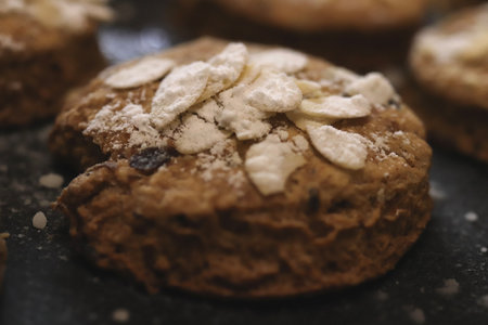 Cookie with almond flakes sprinkled with powdered sugar macro closeupの写真素材