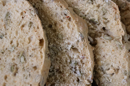 Crunchy tasty handmade freshness with seeds bread slices backdrop.