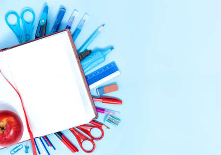 Back to School Conceptl: Notebook and School Supplies. Notebook, Bookmark, Pen, Pencils,  Scissors, Felt Pens, Marker on the Blue Background. Backgroung in Blue, Red and White Colors.の写真素材