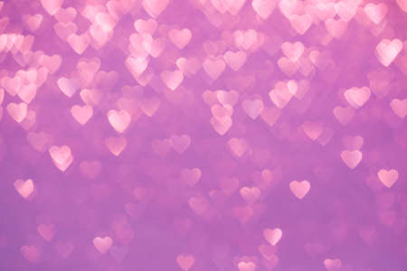 Valentine's Day Concept: Pink Sparklng Defocused Romantic Background of Lights Hearts..
