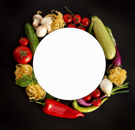 Wreath of Fine Food Products - Fresh Vegetables, Homemade Pasta and Spices on the Black Backgroundの写真素材